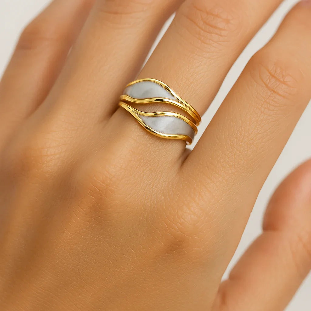 Gold and white wave design ring on hand, minimalist jewelry on model